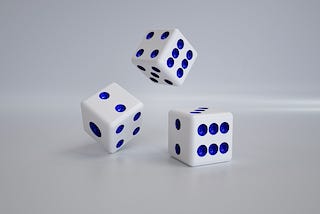 Three dice in various stages of rolling.