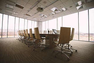 Picture of a conference room with chairs and a Center Table.