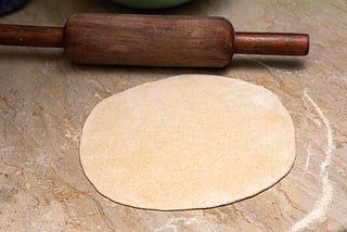 rolled out.A rolling pin with a roti