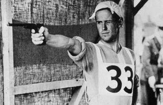 Man in a sports uniform aims a pistol at a target