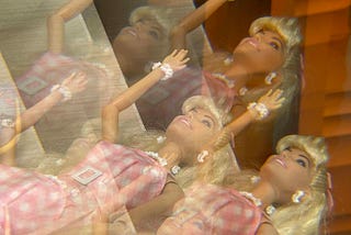 duplicate image of Barbie with pink-checked dress