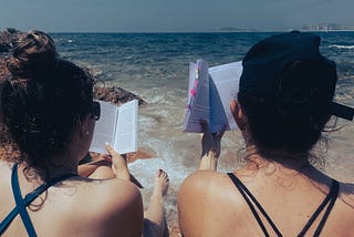 a woman standing next to a body of water