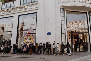 A queue of people outside a Louis Vuitton store in Paris