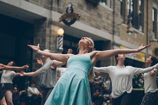 Dancing woman with outstretched arms in a group of dancers. If You Play Special Interest Roulette, You might be the smartest person in the room