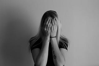 Woman covering her face with her hands