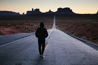 A person walking down a road that requires motivation to keep going.