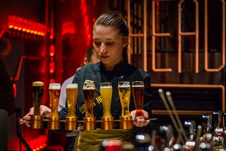 Bartender lining up glasses of beer