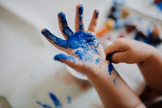 Photo of a kids hand with blue paint