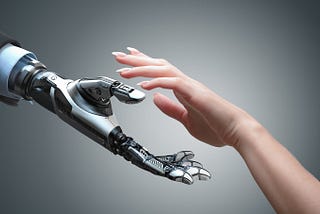 Robot hand shaking human’s hand in partnership