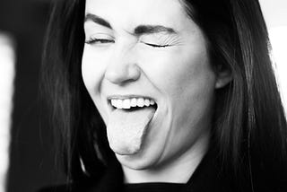 Woman playfully sticking out her tongue.