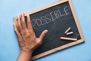 A chalkboard that says impossible, but the “im” is covered to show “possible”