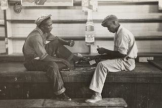 Vintage photo of two working men playing cards