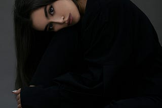 Woman with long dark hair.