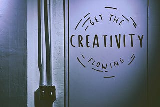A door with the words ‘get the creativity flowing’ painted on it