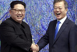 Picture of Kim Jong-un and Moon Jae-in smiling and shaking hands at the April 27, 2018 Inter-Korean Summit