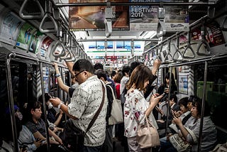 Subway travellers distracted by their smartphones.