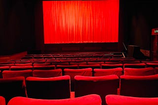 Movie theatre with red curtains.