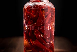 A Kilner jar filled with pickled red chillis