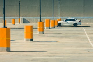 A car park with just one car in it.