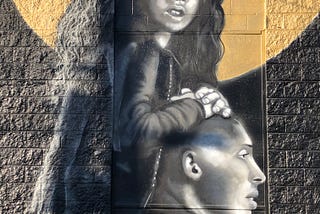 Street art tribute mural of Gianna Bryant riding on Kobe Bryant’s shoulders
