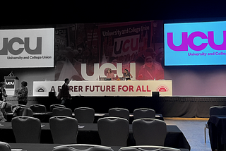 photo of the UCU congress hall, empty, monochrome on the left and in colour on the right