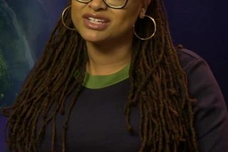 A picture of Ava DuVernay with her black glasses on.