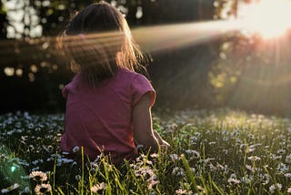 girl in field with sunlight