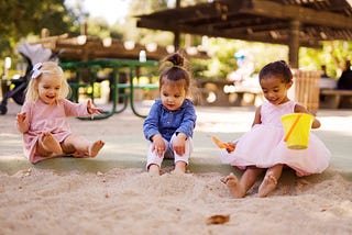 Three kids on the playground having fun