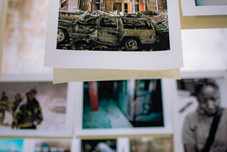 A series of photographs hang from a laundry line.