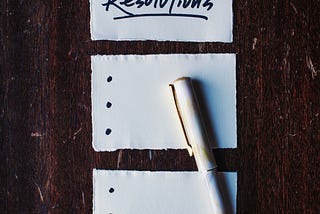 A paper has resolutions at the top and includes bullet points for a list.