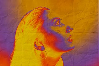 Artsy image of a woman with a colour palette of yellows, oranges, and some blues for shadow