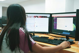 A girl is performing her tasks in front of a computer.
