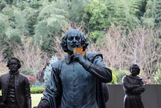 A statue of Shakespeare holds a leaf. I don’t know who the guys behind him are.