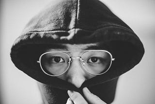 Man hiding the lower half of his face under his sweater