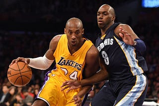 Kobe Bryant drives past Quincy Pondexter during an NBA game in Los Angeles, Jan. 2, 2014.
