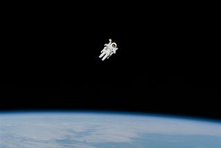 An astronaut drifting off in space