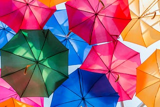 Multicoloured umbrellas suspended in the sky