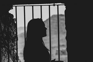 Woman standing inside a prison