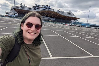 Chris Northwood stood in a car park in front of Southampton cruise terminal and the NCL Prima