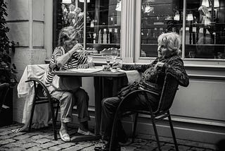 Photo of Elderly Women Sipping Wine on a Patio Outside an Establishment by Jez Timms on Unsplash