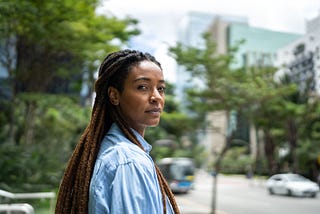 Portrait of a young woman of color outside