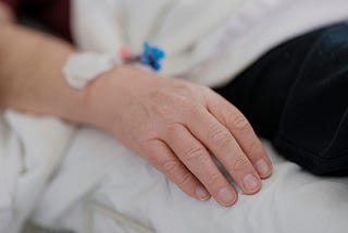 A hospital patient with an IV inserted in the wrist.