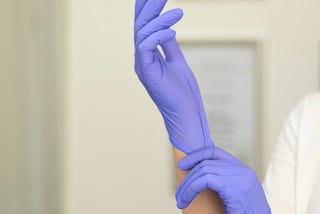 the doctor puts on gloves