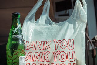 plastic trash bag and bottle of Sprite, waste created from shopping, ways to reduce waste