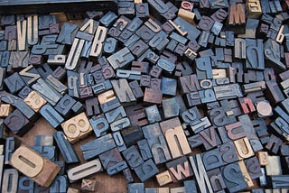 Letter stamps scattered around a wooden surface.