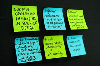 The five principles of the service design team written out on post - it notes