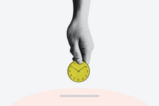 Person holding a yellow, round, analog clock