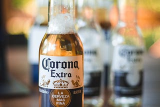 A corona extra beer filled to the neck.