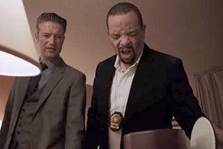 Detectives Carisi and Tutuola look in an ice bucket in a hotel room