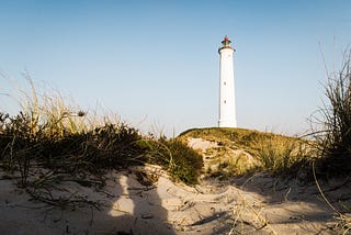 White lighthouse on dunes